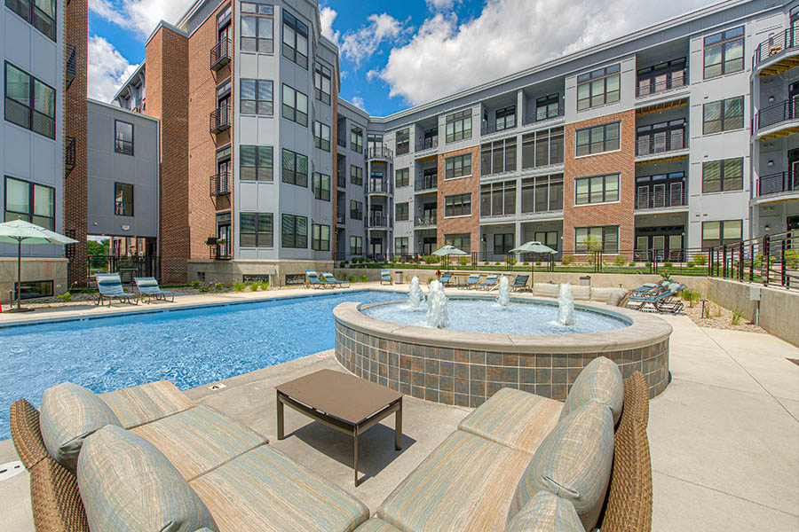 Pool area with hot tub and outdoor seating